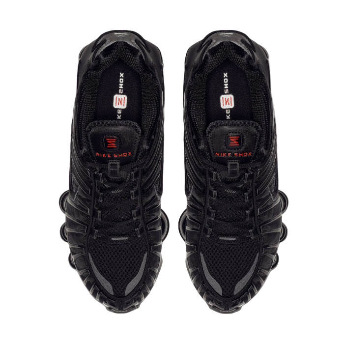 Black Nike sneakers with visible branding on a white background